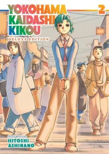 A green-haired android poses in the middle of a busyish street. Her hands are clasped as she faces us. Some of the passersby look at us as well. 

The words "Yokohama Kaidashi Kikou Deluxe Edition," the number 2 and "Story and Art by Hitoshi Ashinano" are in prismatic rainbow colors.