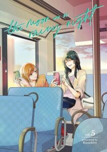 Two girls ride a bus, one with short orange hair, the other withe long black hair. They are conversing on their phones in text, smiling and laughing together.