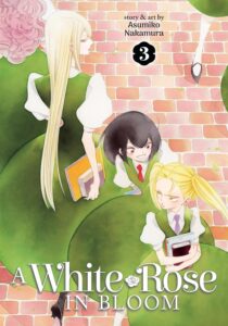 Girls in green dresses with white puffy-shouldered sleeves pass on a brick walkway. A girl with long pale hair walks with a classmate, but looks back at two younger girls, one with blonde pigtails and one with short dark hair as they argue.