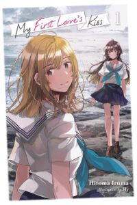 On a rocky shore, two girls in Japanese school uniforms with dark skirts and white sailor-style uniform tops stand. One, with long dark hair, is a distance away. Closer to us is a blonde who looks over right shoulder at us.