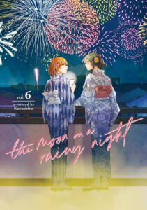 Two young women in summer yukata stand on a balcony looking at one another, as fireworks explode colorfully above them