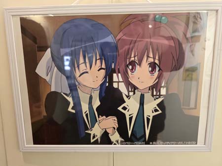 Art from Strawberry Panic! anime showing Nagisa behind held by Tamao. Yuriten 2025, Bea Baker