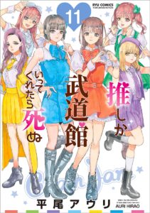 A group of six idols in different colors look at us. In salmon pink, Maina makes a heart with her hands.