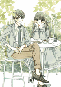 In sepia tones, two girls sit at a garden table, One with long hair, wearing a long skirted dress -style school uniform. holds her chin in her hands as she leans forward. The other girl, short-haired, wears a suit and slacks for her uniform, oxford shoes and no socks, as she sits with her legs crossed. Both gaze relaxedly at us.