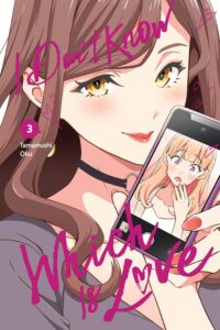 I Don't Know Which Is Love Volume 3 cover. It shows Maria, a pretty lady with long brown hair wearing lipstick, holding up a phone that shows a surprised looking Mei. 